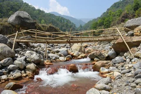 Bamboo bridge over high current himalyan river . Stock-Fotos