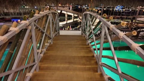 Bamboo bridge over the pool at night Video stock 310493971