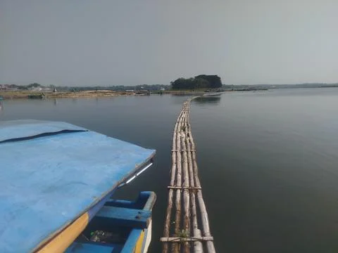 Bamboo bridge over the surface of the lake 스톡 사진
