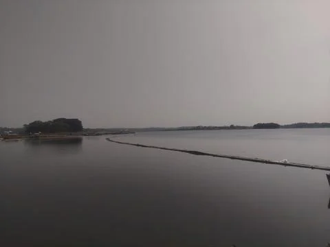 Bamboo bridge over the surface of the lake 스톡 사진