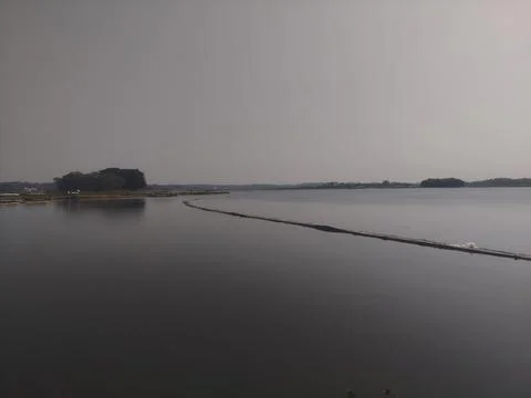 Bamboo bridge over the surface of the lake 스톡 사진