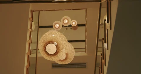Bamboo chandelier hanging from the ceiling down the stairs Video stock 254595955