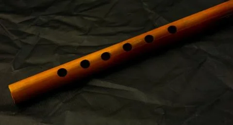 Bamboo flute on a dark background Stock Photos