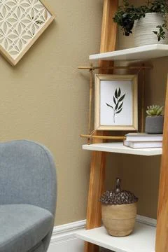 Bamboo frame and different decor elements on shelving unit indoors Stock Photos