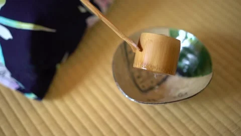 Bamboo ladle adding water Stock Footage 131244769