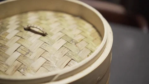Bamboo lid being removed from dumpling cover. Slow Motion.  Video stock 78886650