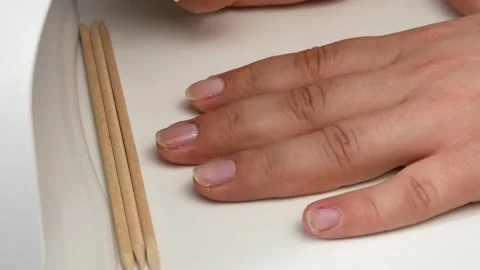 Bamboo manicure stick.Drying the polymer coating in a UV lamp with LEDs. Stock-Footage 133238149