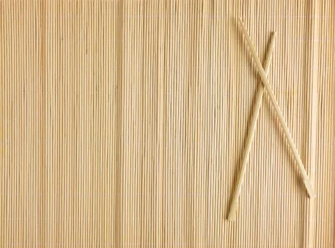 Bamboo Mat for sushi with wooden chopsticks Stock Photos