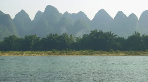 Bamboo raft flowing through the idyllic rural landscape Stock Footage 64828512