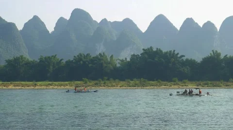 Bamboo raft flowing through the idyllic rural landscape of Yangshuo Stock Footage 64828744