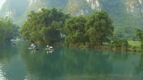Bamboo raft flowing through the idyllic rural landscape of Yangshuo Stock Footage 68893812