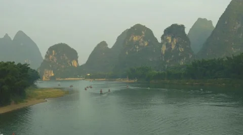 Bamboo rafts flowing through the idyllic rural landscape of China Stock Footage 68893728