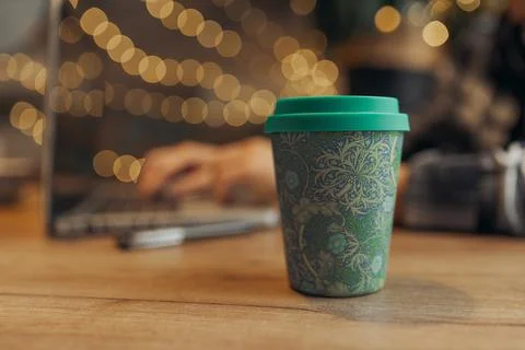 Bamboo reusable cup for coffee on table in cafe. 스톡 사진