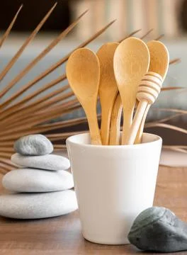 Bamboo spoons in cup on table, disposable tableware from natural materials Stock Photos