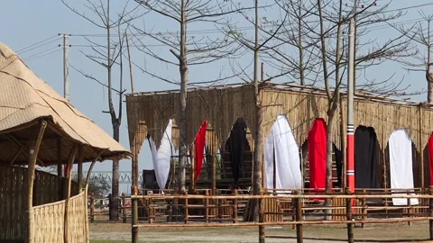 Bamboo structures with colorful fabric decorations in outdoor setting Stock Footage 331277045