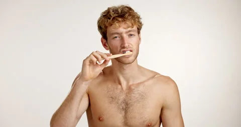 Bamboo toothbrush, face or man in studio white background for smile or hygiene Stock Footage 312405998