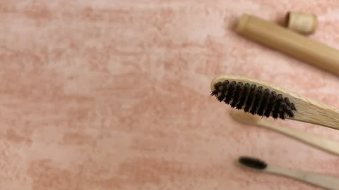 Bamboo toothbrush with natural bristle is demonstrated with space for text Stock Footage 113682331