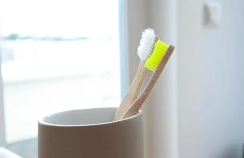 Bamboo toothbrushes close-up on a light background Stock Photos