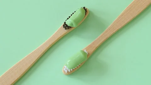 Bamboo toothbrushes with natural toothpaste rotating top view Stock Footage 105059350