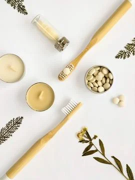 Bamboo toothbrushes, toothpaste in tablets, dental floss, candles, dried flowers Stock Photos