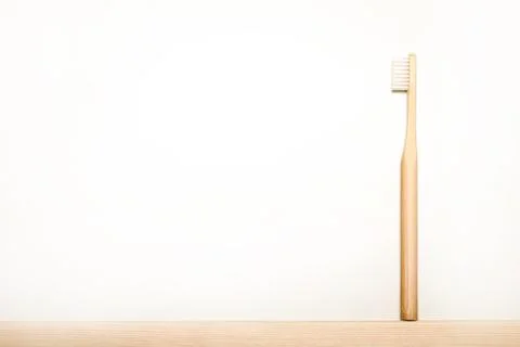 Bamboo toothbrushes on white background. Stock Photos