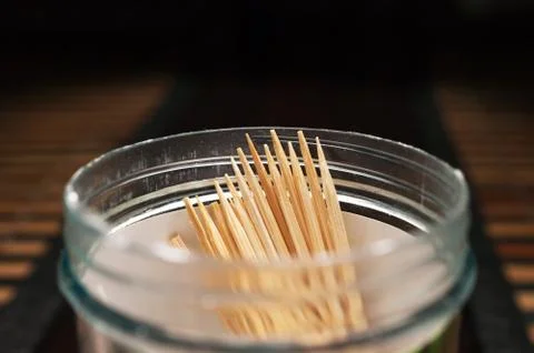 Bamboo Toothpicks in A Plastic Bottle on A Dark Wooden Table Stock Photos