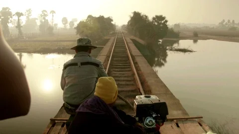 Bamboo Train / Norry Trail / Nori Ride in Battambang/Cambodia crossing a river Video stock 74192858