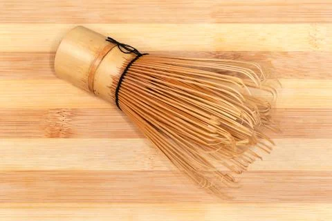 Bamboo whisk for preparing matcha tea on bamboo cutting board Stock Photos