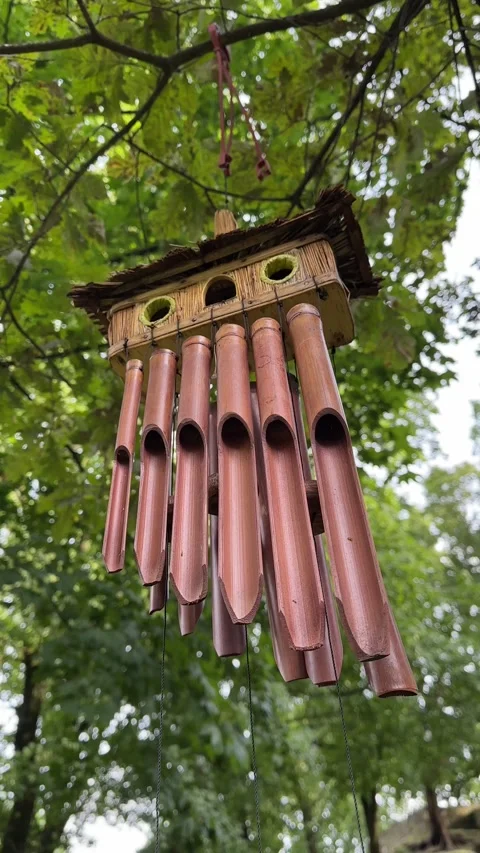 Bamboo Wind Chime Swaying in Breeze in Green Park Video stock 343445102