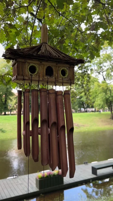Bamboo Wind Chime Swaying in Breeze in Green Park Video stock 343445151