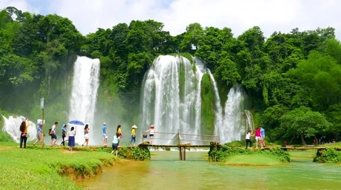Ban Gioc Waterfall - May 2015: Visitors crossing wooden bridge by the waterfall. Stock Footage 52951300