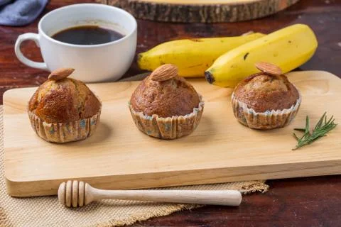 Banana cake on wooden board with banana and coffee for breakfast Stock Photos