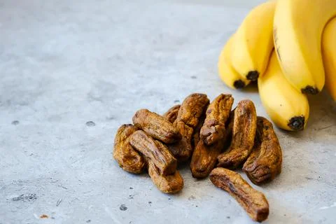 Banana drying process. Different sizes of dried banana. Dried bananas on a co Stock Photos