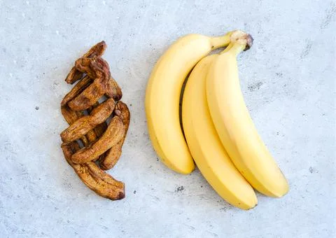 Banana drying process. Different sizes of dried banana. Dried bananas on a co Stock Photos