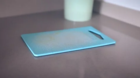 Banana falling on plastic cutting board Video stock 141250210