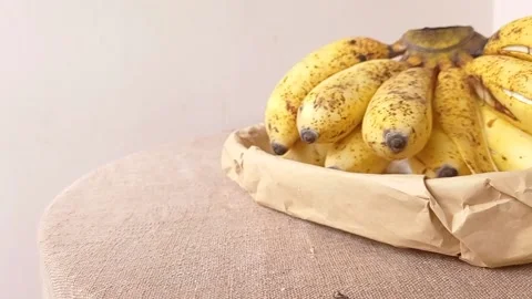Banana fruit on a brown table with a white background Stock Footage 146249003