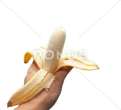 A banana in his hand on a white background Stock Photos