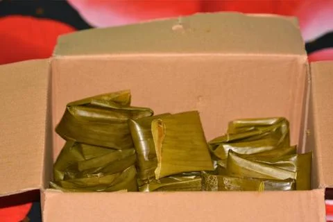 Banana leaf wrapped snacks in open box top view Indonesian catering pack Stock Photos