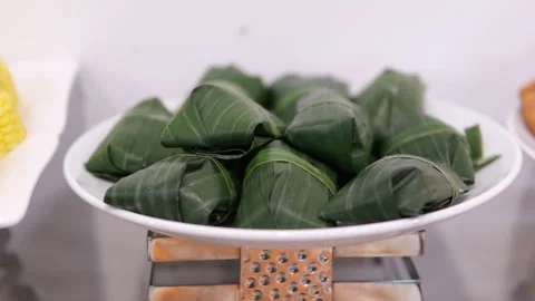 Banana leaf wrapper rotating on isolated white Fresh crabs neatly bundled in Stock Footage 310157509
