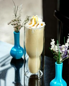Banana milkshake on the table Stock Photos