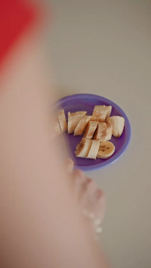 Banana slice preparation. Home kitchen snack with fruit. Preparing banana on Stock Footage 337560927