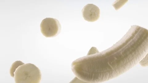 Banana with Slices Falling on White Background Video stock 107943390