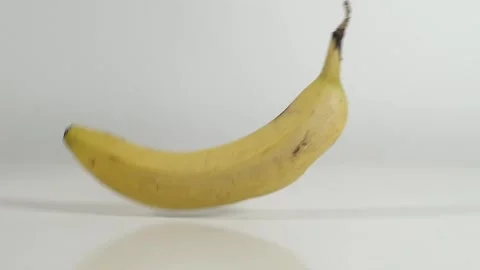 Banana splits open on white table Stock Footage 145326726