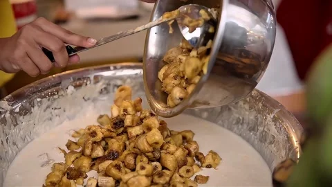 Bananas are put into the batter to make fried bananas Stock Footage 300621176