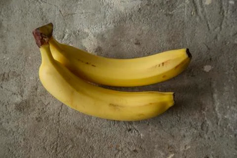 Bananas on a concrete surface (background) Stock Photos