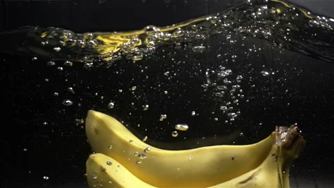 Bananas Falling in Water with Splash in Slow Motion Stock Footage 104722741