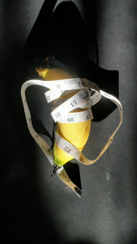 Bananas rolled with measuring tape with Stock Footage 297376894