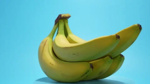 Bananas rotate on a blue background. Stock Footage 280648156
