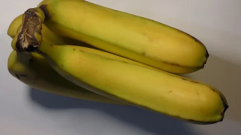Bananas rotating on the white base of wheel Stock Footage 110857809