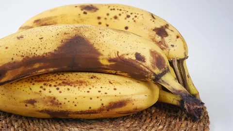 Bananas showing spots on a table Stock Footage 341787003